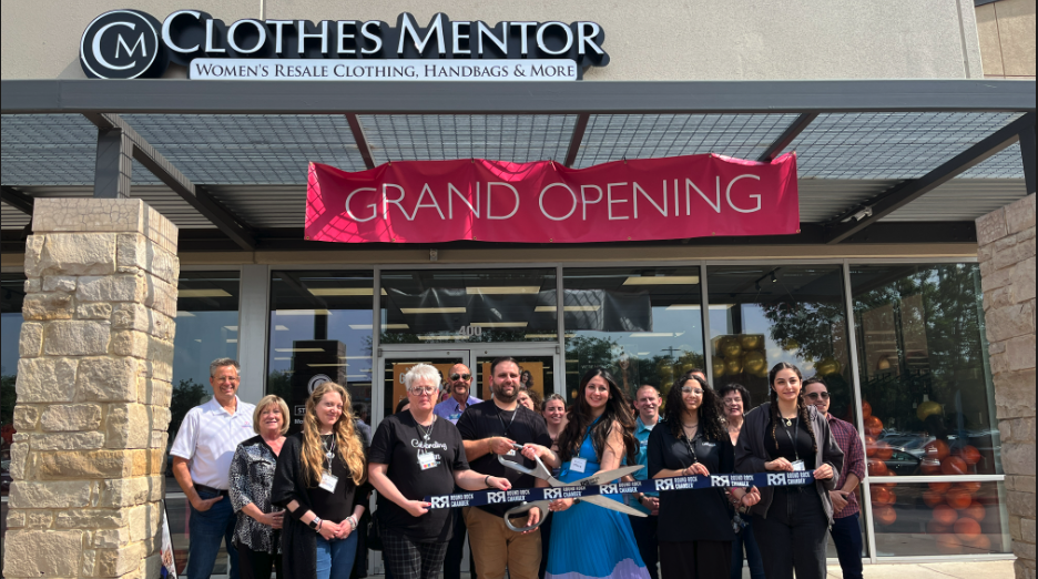 Group of Clothes Mentor employees cutting a ribbon at grand opening